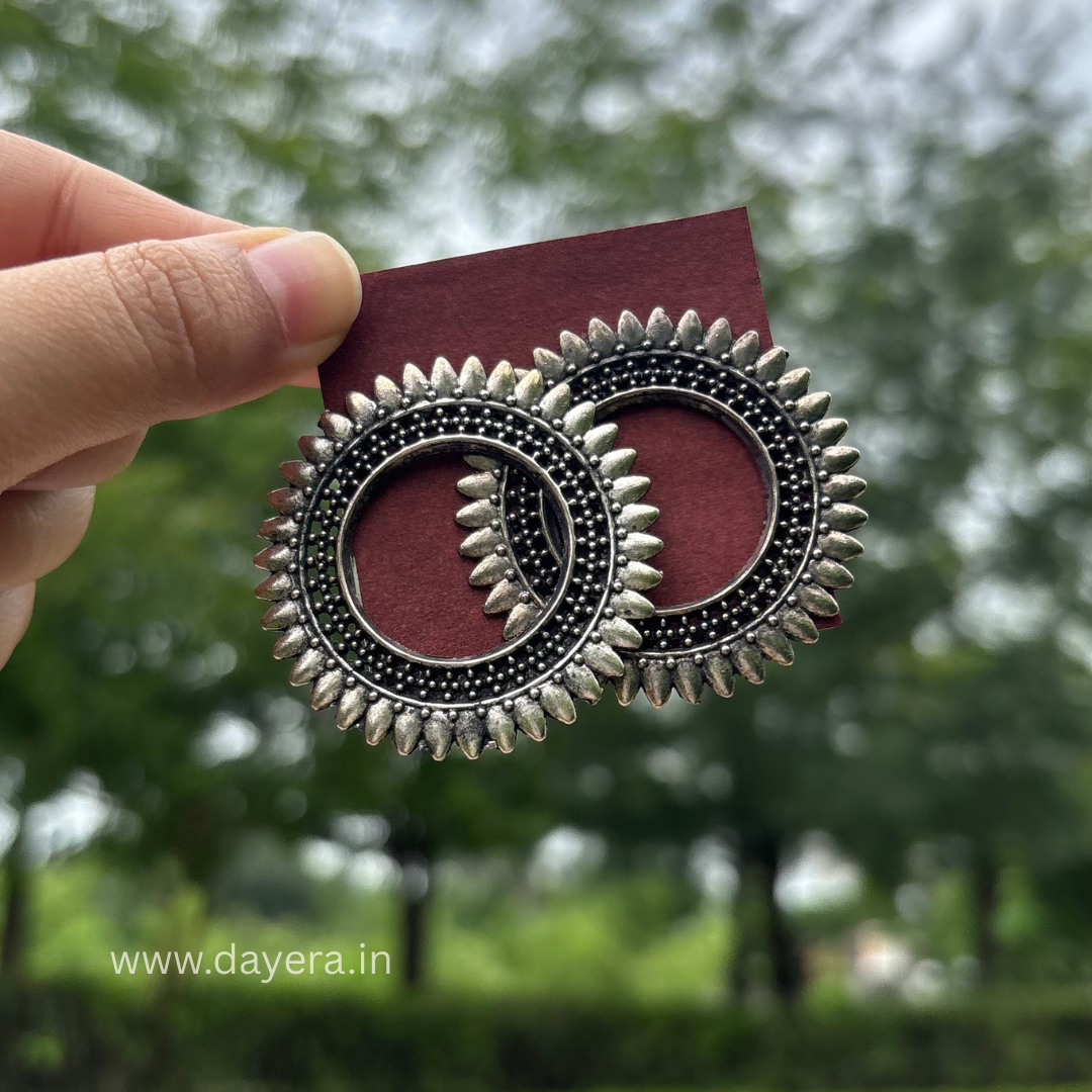 Pushpa Chakra Studs – Premium German Silver Earrings by DAYERA